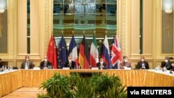 FILE - Participants wait for the start of a meeting of the JCPOA Joint Commission in Vienna, Austria, April 17, 2021. (EU Delegation in Vienna/Handout via Reuters)