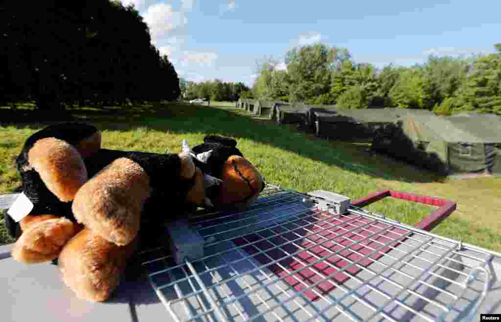A stuffed animal sits on the hill where tents are erected by the Canadian Armed Forces to house asylum seekers at the Canada-U.S. border in Lacolle, Quebec, Aug. 9, 2017.