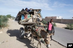 FILE - Somalis are seen leaving the Somali capital Mogadishu, due to hunger, for a refugee camp.