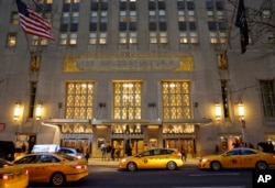 FILE - Taxis pull up in front of the renowned Waldorf Astoria hotel in New York, Feb. 28, 2017. The hotel, purchased by the Anbang Insurance Group, a Chinese company, closed March 1 for two to three years for renovation.