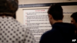 FILE - A young men gather to talk after a 12-step meeting for Internet & Tech Addiction Anonymous in Bellevue, Wash., Dec. 8, 2018.