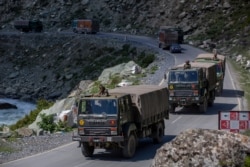 An Indian army convoy moves on the Srinagar- Ladakh highway at Gagangeer, northeast of Srinagar, Indian-controlled Kashmir, Sept. 9, 2020. China and India have been engaged in a tense standoff in the cold-desert Ladakh region since May.
