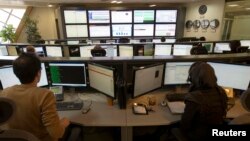 Technicians monitor data flow in the control room of an internet service provider in Tehran, Iran, Feb. 15, 2011. 