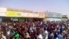 FILE - In this Dec. 25, 2018 handout image provided a Sudanese activist, people chant slogans during a demonstration in Kordofan, Sudan.