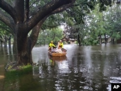 In this photo provided by the Orange County Fire Rescue's Public Information Office, firefighters in Orange County, Fla., help people stranded by Hurricane Ian early Thursday, Sept. 29, 2022.