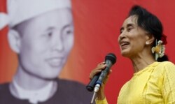 FILE - Myanmar pro-democracy leader Aung San Suu Kyi gives a speech during her campaign rally for the upcoming general election in her constituency Kawhmu township, Yangon Division, Oct. 24, 2015.