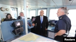 FILE - British Home Secretary Sajid Javid meets Border Force staff on board the HMC Searcher in Dover, Britain, Jan. 2, 2019. 