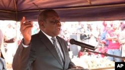 MDC leader Morgan Tsvangirai speaks at the burial of an activist in Harare, Aug. 14, 2013.