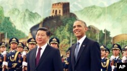 Chinese President Xi Jinping, left, and U.S. President Obama participate in a welcome ceremony for President Obama at the Great Hall of the People in Beijing, China Wednesday, Nov. 12, 2014. (AP Photo/Andy Wong)