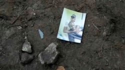 A family snapshot lays on the ground near a trail used by migrants, near Acandi, Colombia, Sept. 15, 2021.