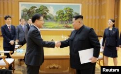 문재인 한국 대통령의 대북특별사절단 수석특사인 정의용 청와대 국가안보실장이 지난 3월 5일 김정은 북한 국무위원장과 만나 악수하고 있다.