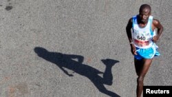 FILE - The shadow of runner is seen in the Nairobi Marathon.