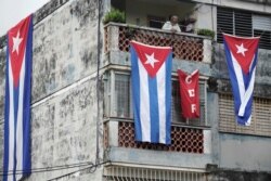 Cuban flags cover the windows of the house of actor, playwright and leader of the Facebook group called Archipelago, Yunior Garcia, in Havana, Cuba, November 15, 2021.