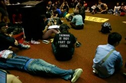 FILE - Students protesting against a China-Taiwan trade pact occupy the legislature floor, in Taipei, Taiwan, March 20, 2014.