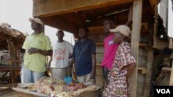 As Muslim traders flee the country and meat is in short supply, a solitary Muslim butcher waits in his stall, Bangui, CAR, Feb. 11, 2104.(Nicholas Long/VOA)