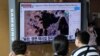 People watch a TV screen showing a file satellite image of the Yongbyon nuclear site in North Korea during a news program at the Seoul Railway Station in Seoul, South Korea, Aug. 30, 2021. 