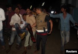 FILE - A wounded man is taken to a hospital by local people after a bomb blast in Sylhet, Bangladesh, March 25, 2017.