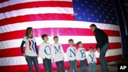 Republican presidential candidate, former Massachusetts Gov. Mitt Romney, greets the Fisher family backstage prior to a campaign rally in Elko, Nev., Friday, Feb. 3, 2012.