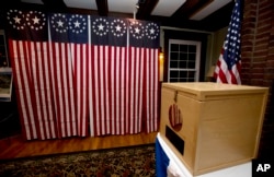 FILE - A ballot box is set for residents to vote in Dixville Notch, New Hampshire, Nov. 7, 2016. A request for detailed information about every voter in the U.S. from President Donald Trump's voting commission got a rocky reception in some states.