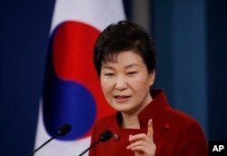 FILE - South Korean President Park Geun-hye answers to a reporter's question during her news conference at the Presidential Blue House in Seoul, South Korea, Jan. 13, 2016.