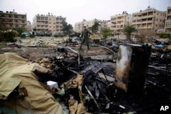 A Russian soldier checks a burned medical tent after rebels launched a mortar shell at a field hospital in west Aleppo, Syria, Dec. 5, 2016. Rebel shelling of the government-held part of Syria's Aleppo city killed a Russian female nurse.