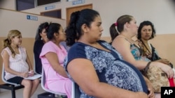 FILE - Women wait their turn for pre-natal exams at the National Hospital for Women in San Salvador, El Salvador, Jan. 29, 2016.