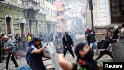 Demonstrators clash with riot police during protests after Ecuador's President Lenin Moreno's government ended four-decade-old fuel subsidies, in Quito, Ecuador, Oct. 3, 2019. 