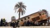 FILE - People gather at the site of a train derailment near Beni Suef, Egypt, Thursday, Feb. 11, 2016 that injured dozens of people were injured as it was traveling north toward Cairo. Railroad accidents due to negligence are common in Egypt.