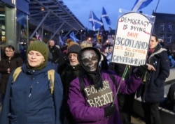 Anti-Brexit protesters hold banners outside the Scottish parliament, in Edinburgh, Scotland, Britain, Jan. 31, 2020.