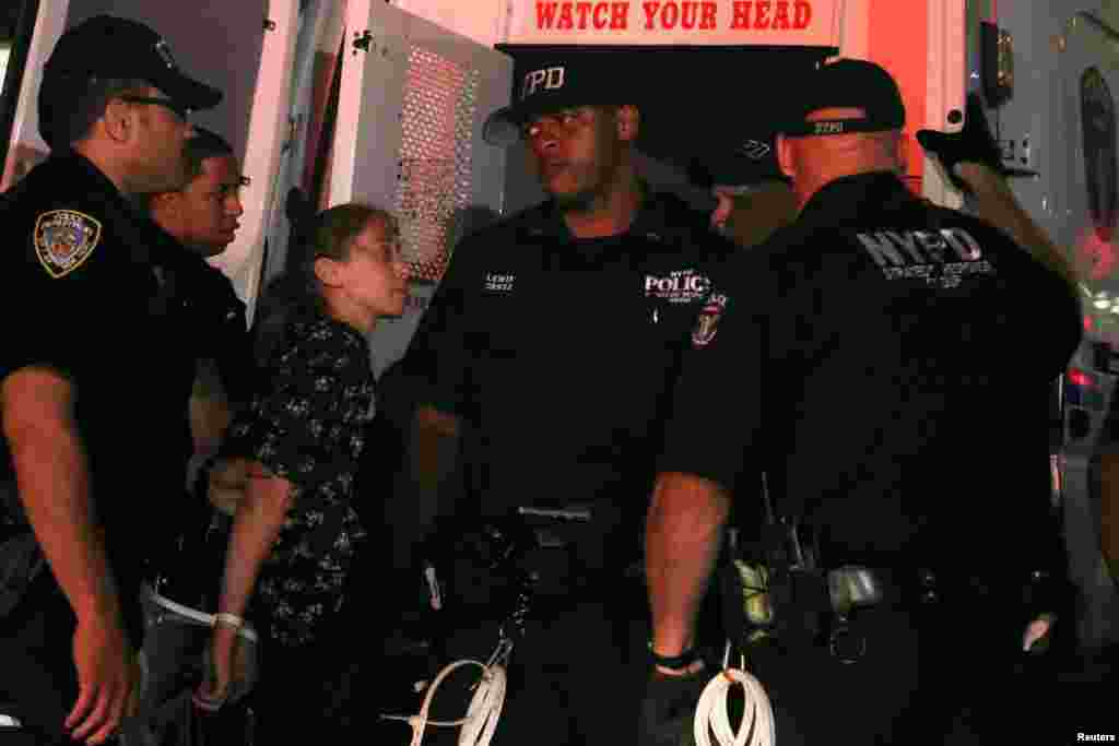 A protester is loaded into a NYPD police vehicle after being arrested during a march held against police brutality in Manhattan, New York, July 9, 2016. 