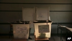 Completed ballots are inside boxes inside a polling station, during the first round of the parliamentary election, in the Imbaba district of Giza, near Cairo, Egypt, Monday, Oct. 19, 2015.