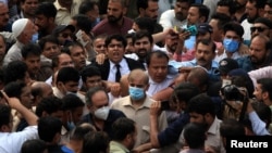 Shehbaz Sharif, brother of former Prime Minister Nawaz Sharif and leader of Pakistan Muslim League-Nawaz (PML-N), walks with lawyers and supporters after the High Court rejected a bail plea in a money laundering case in Lahore, Pakistan, Sept. 28, 2020.