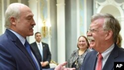 John Bolton, US National Security Advisor, right, is welcomed by Belarusian President Alexander Lukashenko during their meeting in Minsk, Belarus, Thursday, Aug. 29, 2019. 
