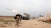 FILE - Iraqi soldiers fire a rocket toward Islamic State militants on the outskirts of the Makhmour south of Mosul, Iraq, March 25, 2016. 