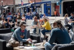 People dine at a restaurant as COVID-19 restrictions are eased in Ann Arbor, Michigan, Apr. 4, 2021.