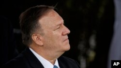 Menteri Luar Negeri Mike Pompeo mendengarkan Presiden Donald Trump yang sedang berpidato dalam upacara pelantikan Ketua Kepala Staf Gabungan Jenderal Mark Milley di Pangkalan Bersama Myer-Henderson Hall, Virginia, 30 September 2019.