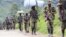 M23 rebel fighters walk as they withdraw near the town of Sake, west of Goma in eastern Congo, November 30, 2012. 