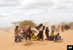 FILE - Newly arrived Somali refugees wait outside a UNHCR processing center at the Ifo refugee camp outside Dadaab, eastern Kenya, 100 kilometers (62 miles) from the Somali border.