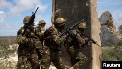 Kenya Defence Forces Rangers, who are part of the African Mission in Somalia (AMISOM), secure an area during a foot patrol on the outskirts of the controlled area of the old airport in the coastal town of Kismayu in southern Somalia, Nov. 12, 2013.