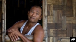 Myint Naing looks out from his sister's house in Mudon, Mon State, Myanmar, April 8, 2017. Naing, one of the enslaved fishermen who was freed more than two years ago, have been forced to travel hundreds of miles to find back-breaking labor that pays only 