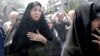 FILE - Iranians attend the funeral of victims of an Islamic State militant attack in Tehran, Iran, June 9, 2017.