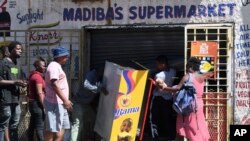 Looters make off with goods from a store on the outskirts of Johannesburg, Sept. 2, 2019.