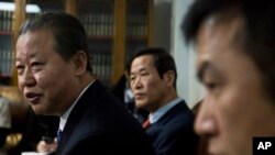 North Korea's U.N. Ambassador Jang II Hun, left, is seated between North Korea's mission consulars Kin Song, center, and Kwon Jong Gun, right, as he speaks during a press conference, Monday, Feb. 16, 2015.