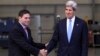 Colombia's Defense Minister Juan Carlos Pinzon (L) shakes hands with U.S. Secretary of State John Kerry during a visit to the anti-narcotics department in Bogota, August 12, 2013. 