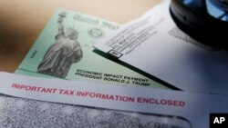 FILE - In this April 23, 2020, photo, President Donald Trump's name is seen on a stimulus check issued by the IRS to help combat the adverse economic effects of the coronavirus outbreak.