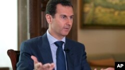 FILE - In this Wednesday, Sept. 21, 2016 photo released by the Syrian Presidency, Syrian President Bashar Assad speaks to The Associated Press at the presidential palace in Damascus, Syria.