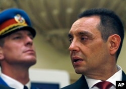 FILE - Serbian Defense Minister Aleksandar Vulin, right, attends the government swearing-in ceremony at the Serbian Parliament building, in Belgrade, Serbia, June 29, 2017.