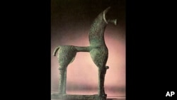 This undated photo provided by the Greek Culture Ministry on Wednesday, June 10, 2020, shows an 8th Century B.C. figurine of a horse from the so-called Geometric period of ancient Greek art that was listed for auction by Sotheby's in New York in May 2018.