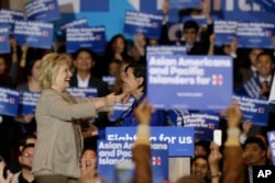 FILE - Democratic presidential candidate Hillary Clinton, left, greets Rep. Judy Chu of California before addressing Asian-American and Pacific Islander supporters in San Gabriel, Calif., Jan. 7, 2016.