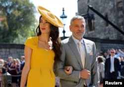 Amal Clooney dan George Clooney saat menghadiri pernikahan Pangeran Harry dan Meghan Markle di Kapel St George's Chapel di Kastil Windsor, 19 Mei 2018.